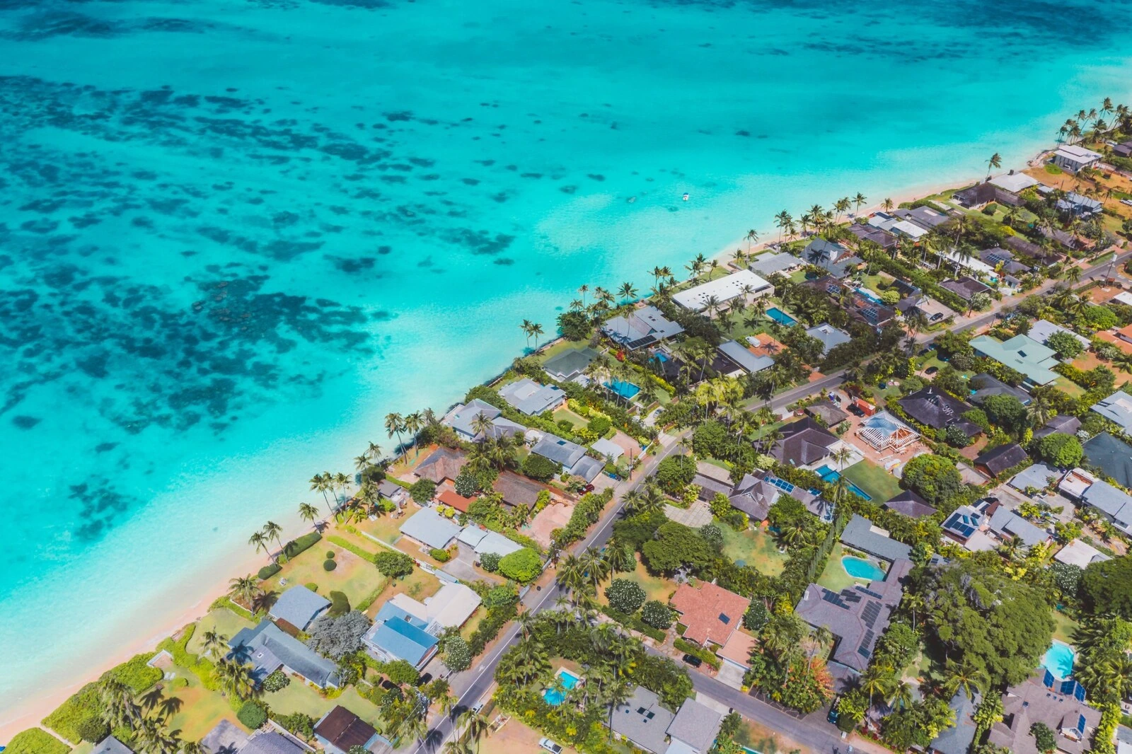 Aerial view of coastal homes and turquoise water in Kailua