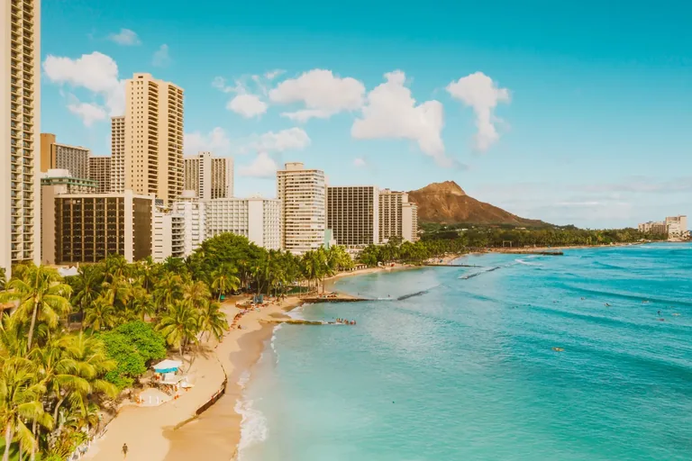 Waikīkī shoreline and beachfront buildings with Diamond Head in the distance