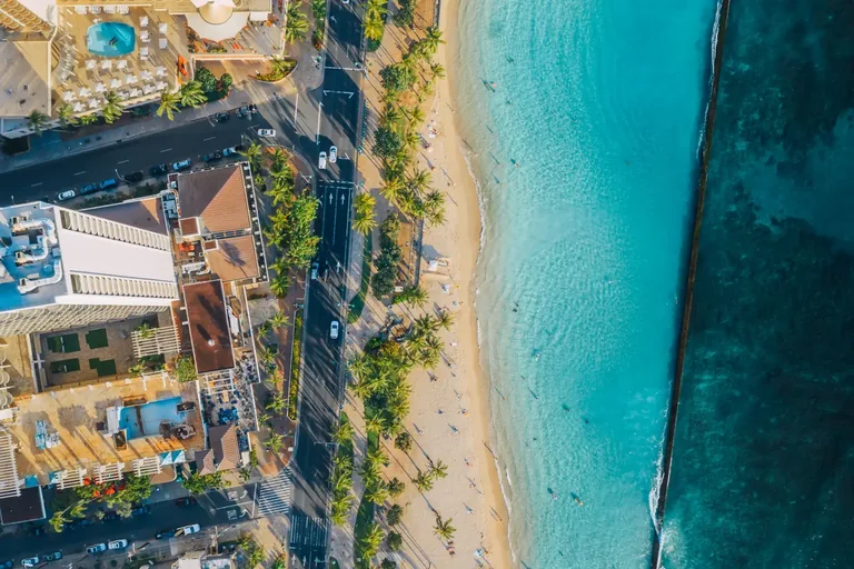 Aerial view of Waikīkī Beach, the shoreline, and coastal buildings in Honolulu