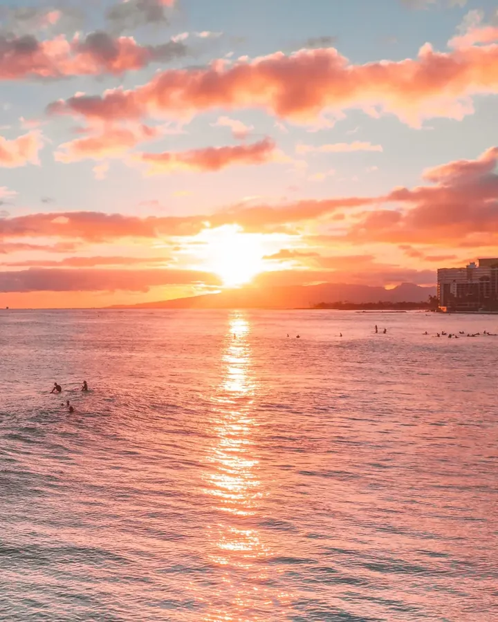 Sunset reflecting across the ocean at Waikīkī Beach